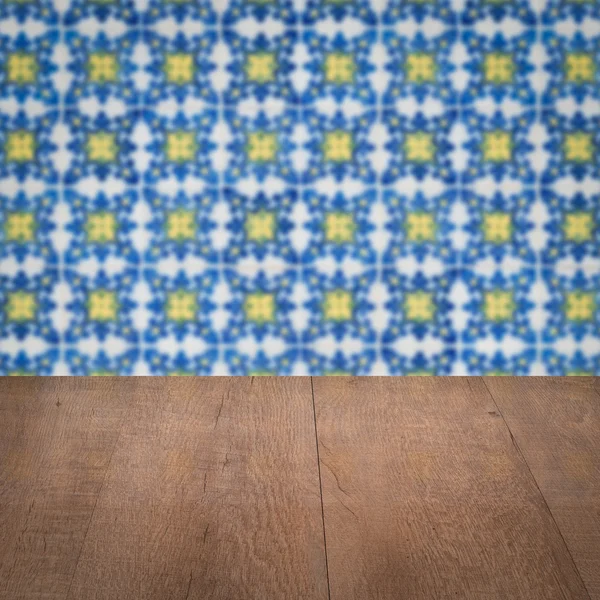 Wood table top and blur vintage ceramic tile pattern wall — Stock Photo, Image