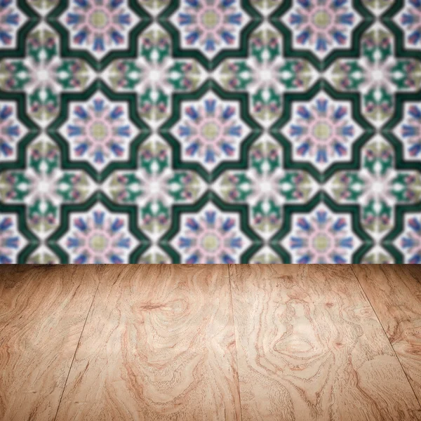 Wood table top and blur vintage ceramic tile pattern wall — Stock Photo, Image