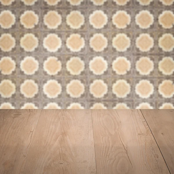 Wood table top and blur vintage ceramic tile pattern wall — Stock Photo, Image