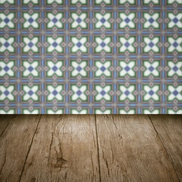 Wood table top and blur vintage ceramic tile pattern wall — Stock Photo, Image