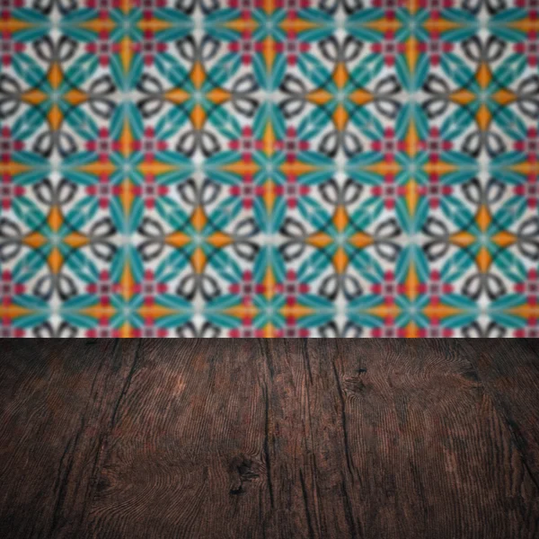 Wood table top and blur vintage ceramic tile pattern wall — Stock Photo, Image