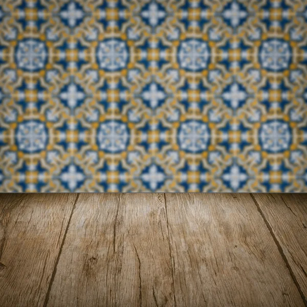 Wood table top and blur vintage ceramic tile pattern wall — Stock Photo, Image