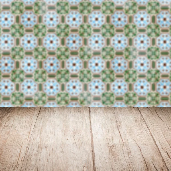 Wood table top and blur vintage ceramic tile pattern wall — Stock Photo, Image