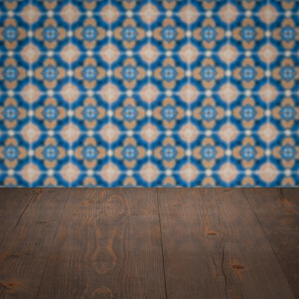 Wood table top and blur vintage ceramic tile pattern wall — Stock Photo, Image