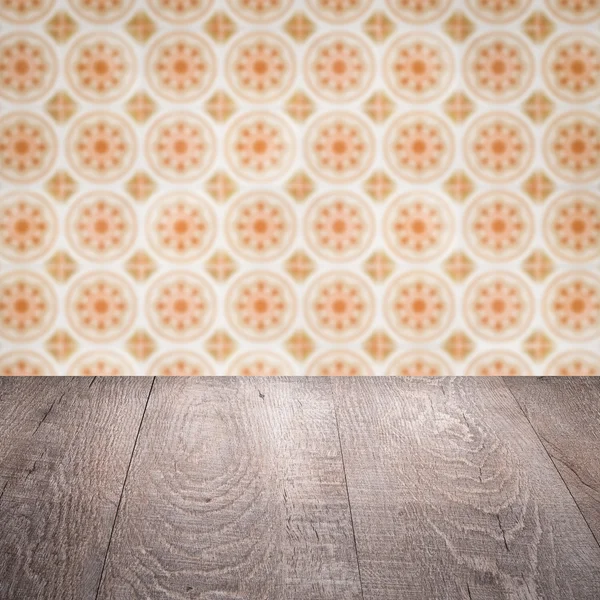 Wood table top and blur vintage ceramic tile pattern wall — Stock Photo, Image