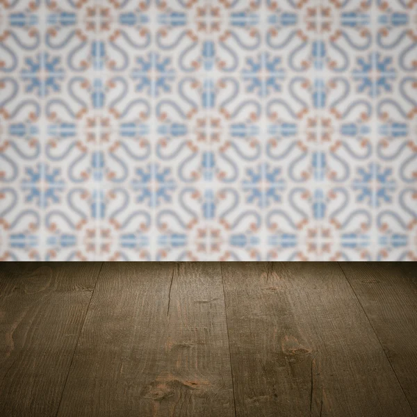 Wood table top and blur vintage ceramic tile pattern wall — Stock Photo, Image