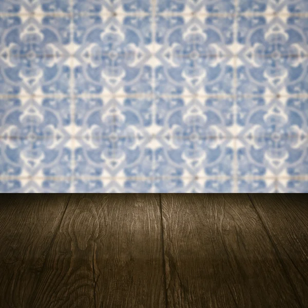 Wood table top and blur vintage ceramic tile pattern wall — Stock Photo, Image