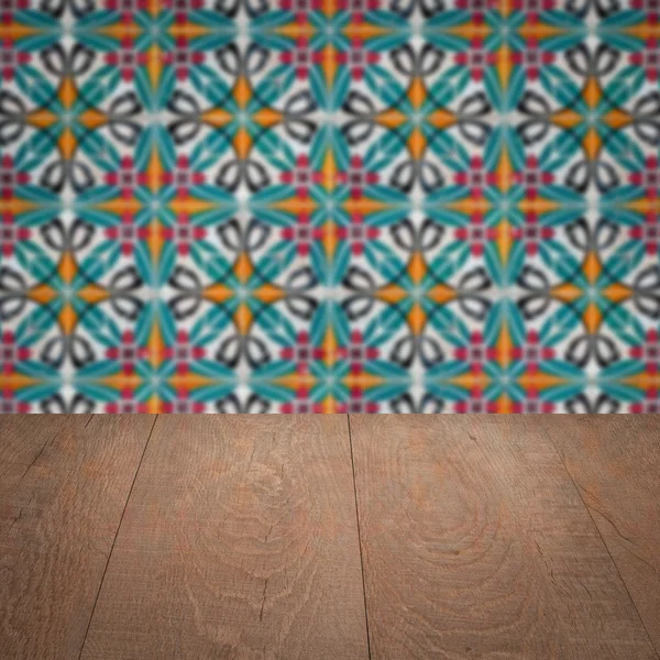 Wood table top and blur vintage ceramic tile pattern wall — Stock Photo, Image