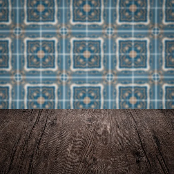 Wood table top and blur vintage ceramic tile pattern wall — Stock Photo, Image