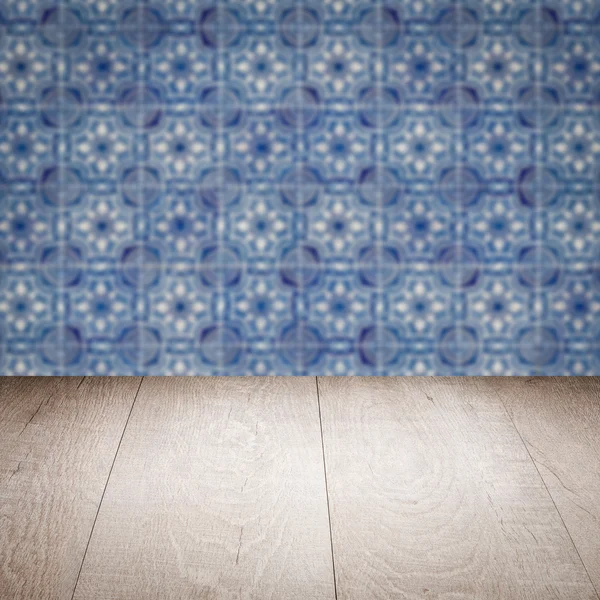 Wood table top and blur vintage ceramic tile pattern wall — Stock Photo, Image