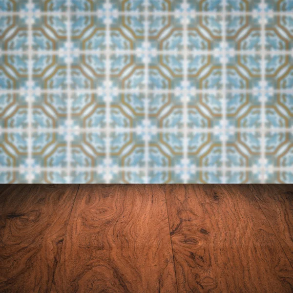 Wood table top and blur vintage ceramic tile pattern wall — Stock Photo, Image