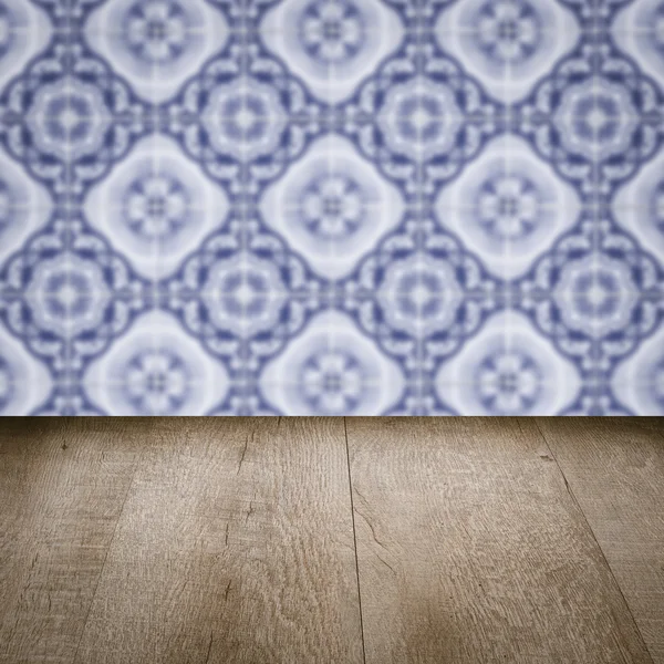 Wood table top and blur vintage ceramic tile pattern wall — Stock Photo, Image