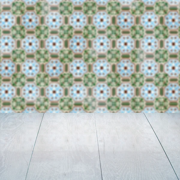 Wood table top and blur vintage ceramic tile pattern wall — Stock Photo, Image