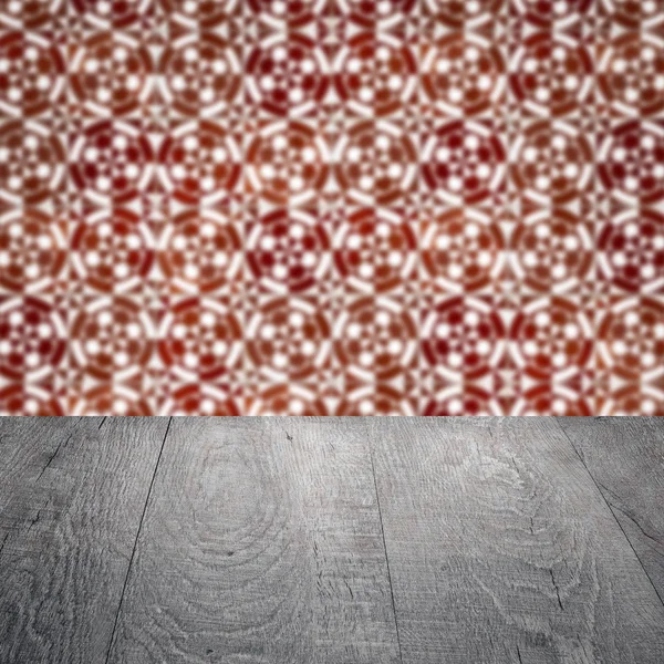 Wood table top and blur vintage ceramic tile pattern wall — Stock Photo, Image