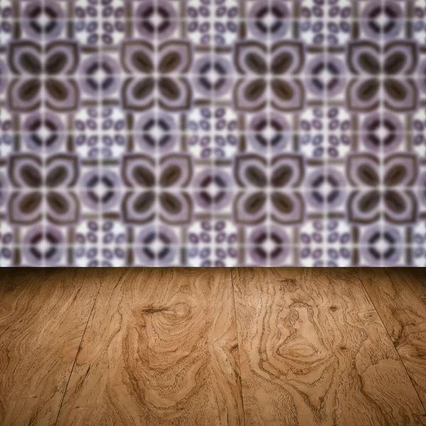 Wood table top and blur vintage ceramic tile pattern wall — Stock Photo, Image