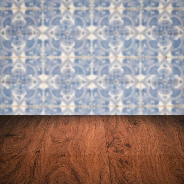 Wood table top and blur vintage ceramic tile pattern wall — Stock Photo, Image