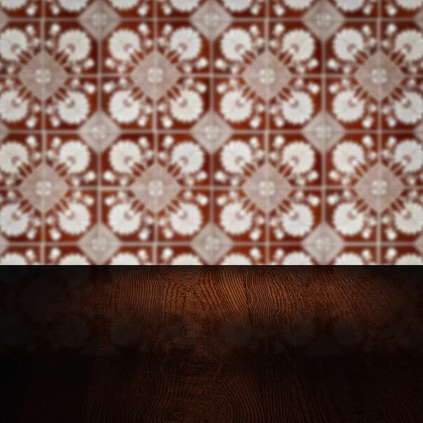 Wood table top and blur vintage ceramic tile pattern wall — Stock Photo, Image