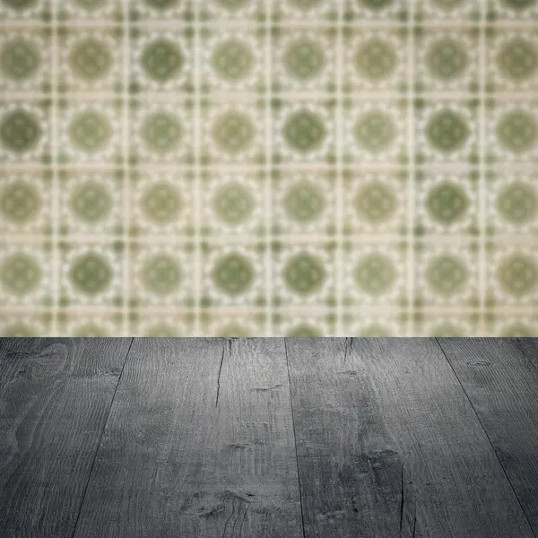 Wood table top and blur vintage ceramic tile pattern wall — Stock Photo, Image