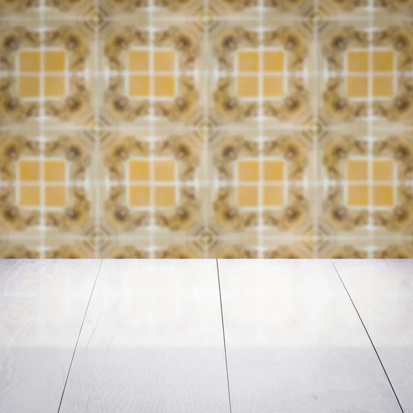 Wood table top and blur vintage ceramic tile pattern wall — Stock Photo, Image