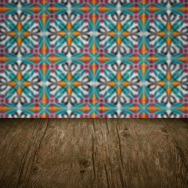 Wood table top and blur vintage ceramic tile pattern wall — Stock Photo, Image