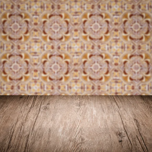 Wood table top and blur   ceramic tile pattern wall — Stock Photo, Image