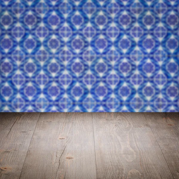 Wood table top and blur   ceramic tile pattern wall — Stock Photo, Image