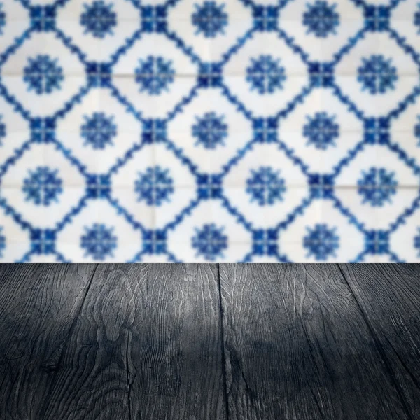 Wood table top and blur vintage ceramic tile pattern wall — Stock Photo, Image