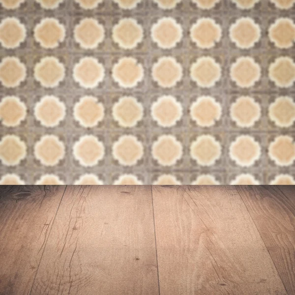 Wood table top and blur vintage ceramic tile pattern wall — Stock Photo, Image