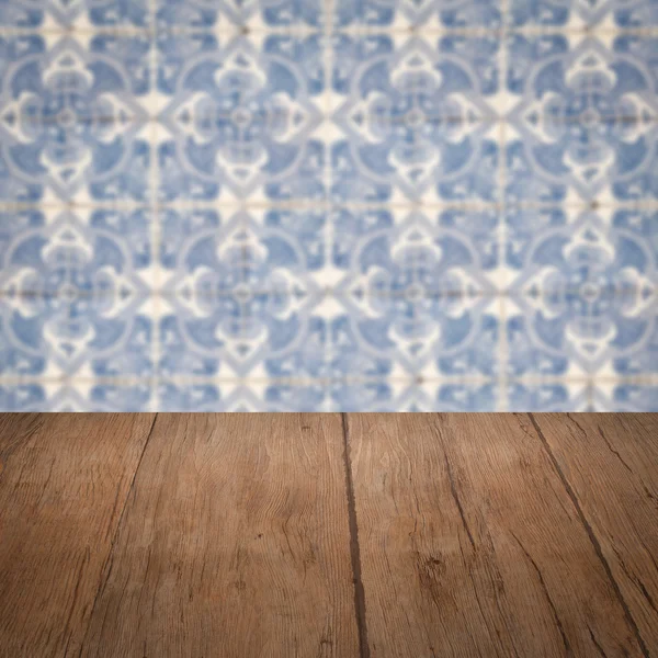 Wood table top and blur vintage ceramic tile pattern wall — Stock Photo, Image