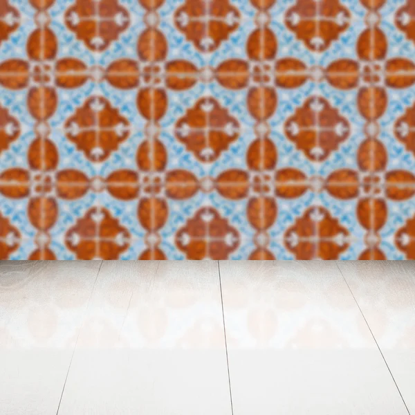 Wood table top and blur vintage ceramic tile pattern wall — Stock Photo, Image