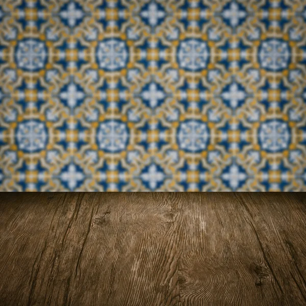 Wood table top and blur vintage ceramic tile pattern wall — Stock Photo, Image