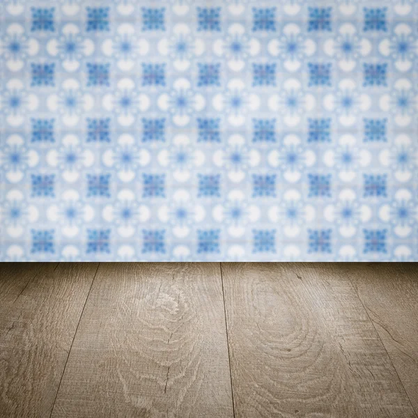 Wood table top and blur vintage ceramic tile pattern wall — Stock Photo, Image