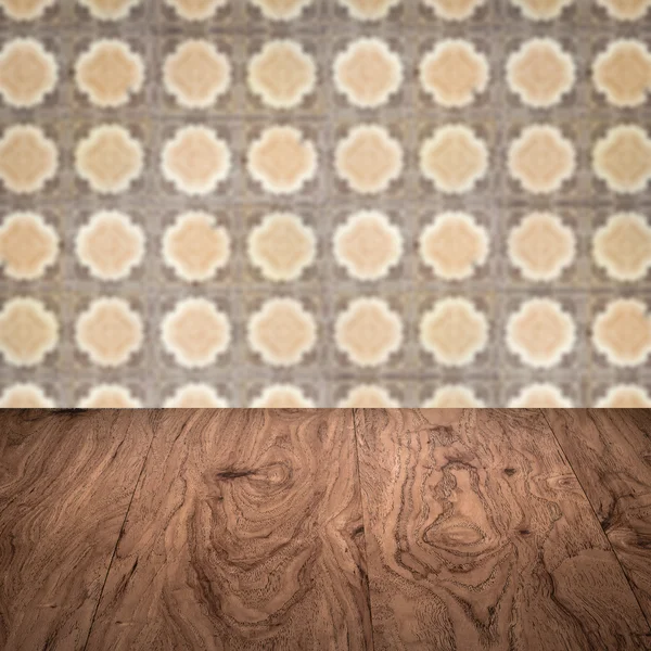 Wood table top and blur vintage ceramic tile pattern wall — Stock Photo, Image