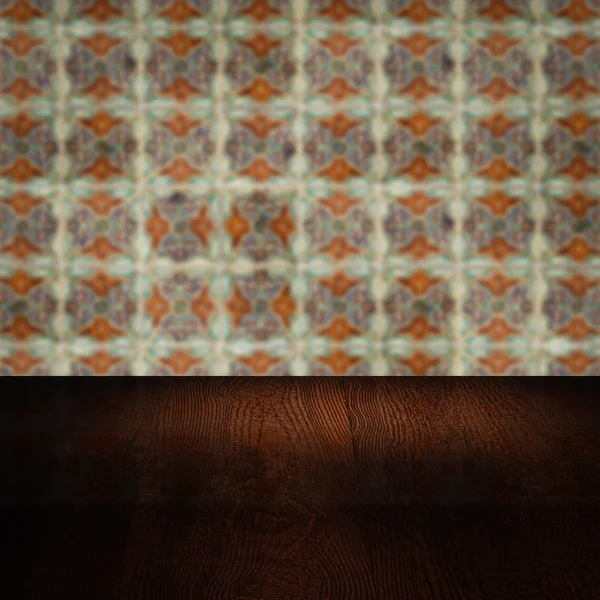 Wood table top and blur vintage ceramic tile pattern wall Royalty Free Stock Photos