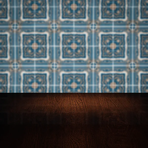 Wood table top and blur vintage ceramic tile pattern wall — Stock Photo, Image