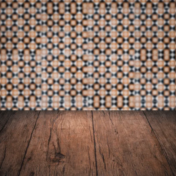 Wood table top and blur vintage ceramic tile pattern wall — Stock Photo, Image