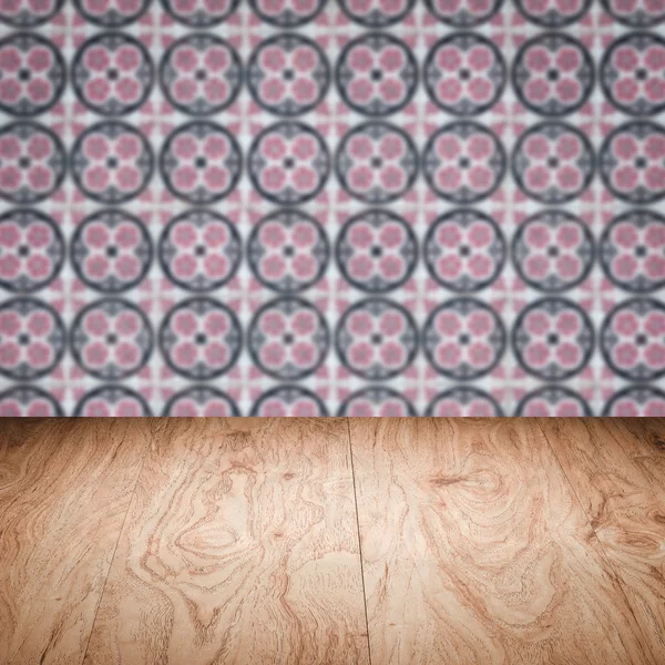 Wood table top and blur vintage ceramic tile pattern wall — Stock Photo, Image