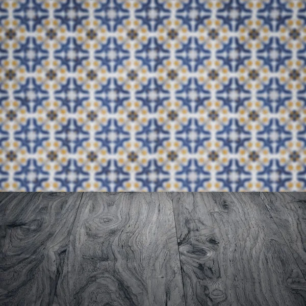 Wood table top and blur vintage ceramic tile pattern wall — Stock Photo, Image