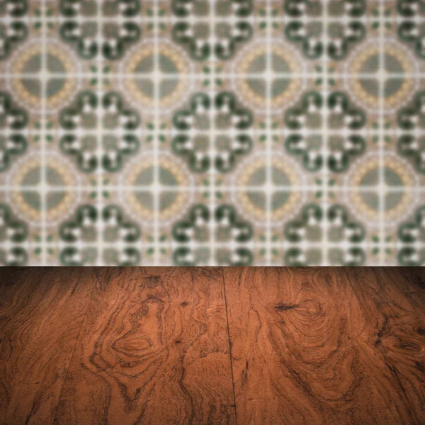 Wood table top and blur vintage ceramic tile pattern wall — Stock Photo, Image