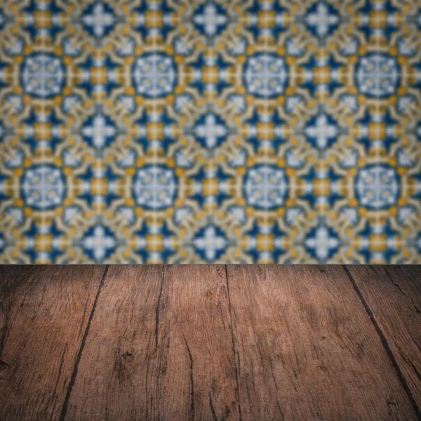 Wood table top and blur vintage ceramic tile pattern wall — Stock Photo, Image