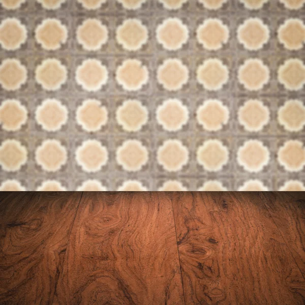 Wood table top and blur vintage ceramic tile pattern wall — Stock Photo, Image