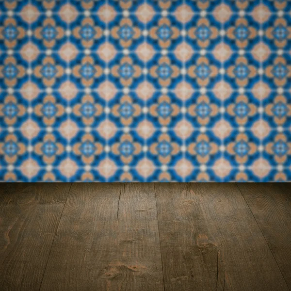 Wood table top and blur vintage ceramic tile pattern wall — Stock Photo, Image