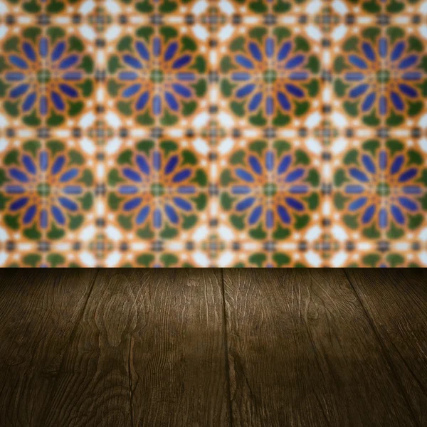 Wood table top and blur vintage ceramic tile pattern wall — Stock Photo, Image