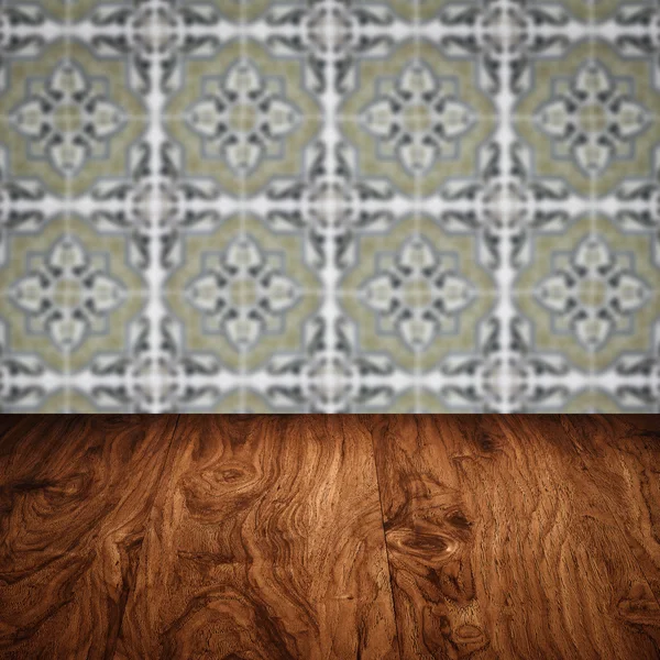 Wood table top and blur vintage ceramic tile pattern wall — Stock Photo, Image