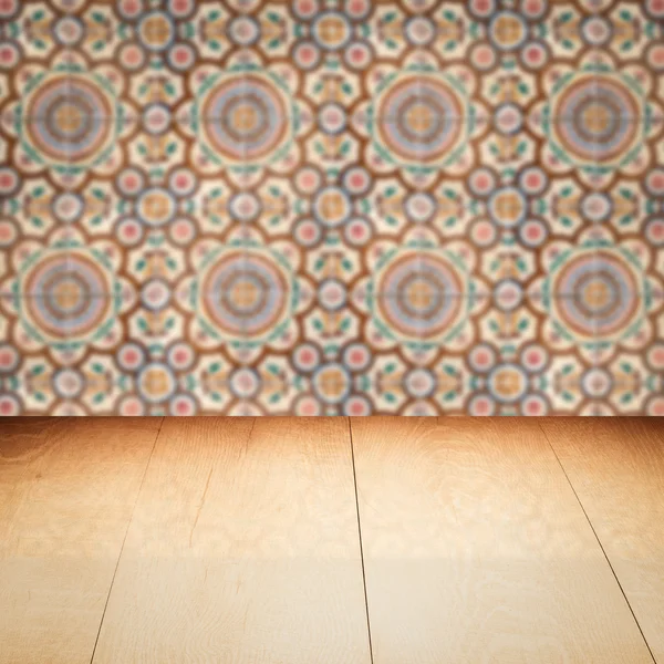 Wood table top and blur vintage ceramic tile pattern wall — Stock Photo, Image