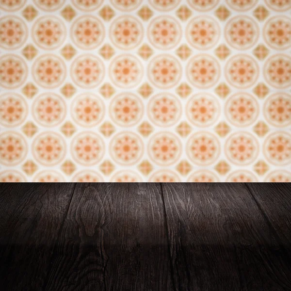 Wood table top and blur vintage ceramic tile pattern wall — Stock Photo, Image