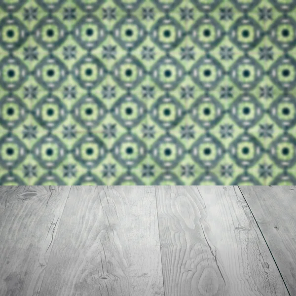 Wood table top and blur vintage ceramic tile pattern wall — Stock Photo, Image