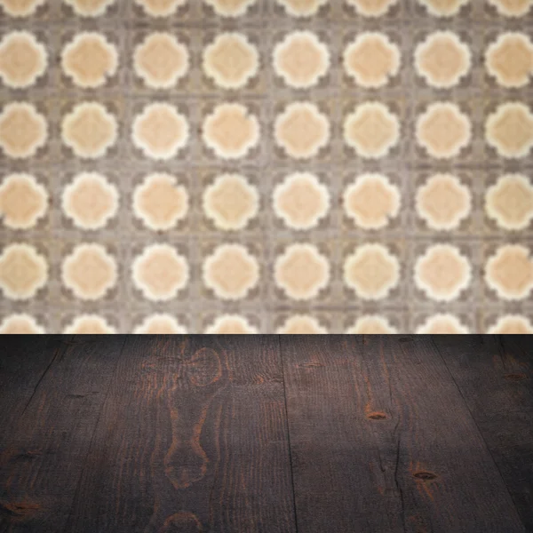 Wood table top and blur vintage ceramic tile pattern wall — Stock Photo, Image