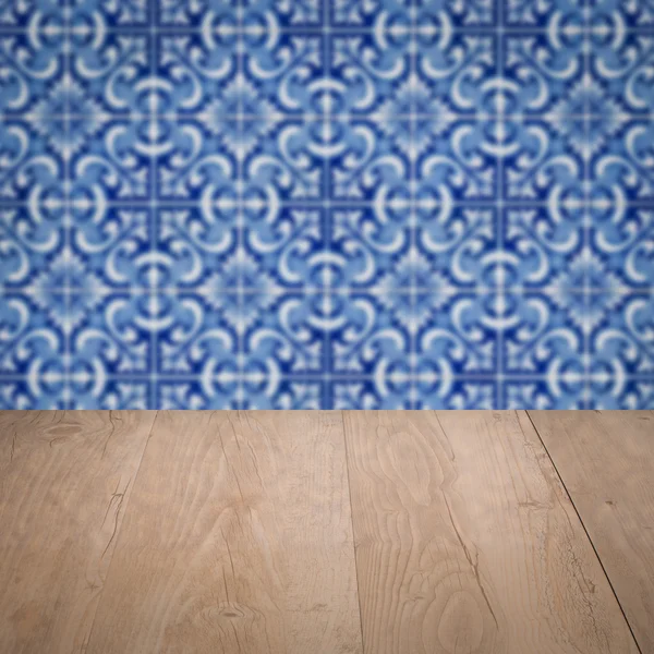 Wood table top and blur vintage ceramic tile pattern wall — Stock Photo, Image