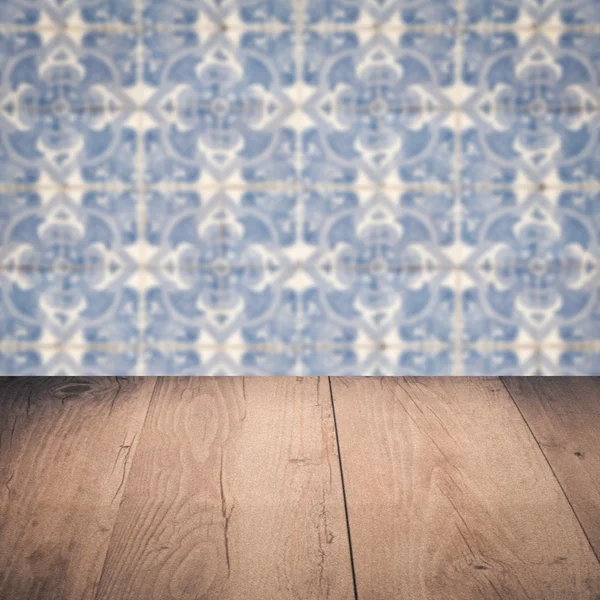 Wood table top and blur vintage ceramic tile pattern wall — Stock Photo, Image